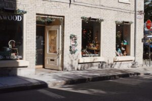 Sparkling clean storefront window with warm holiday lights on a downtown street